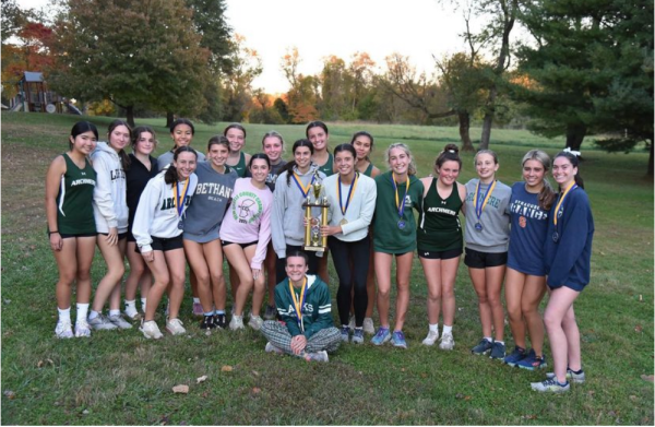 The Girls Cross Country team after placing first in their division championship
